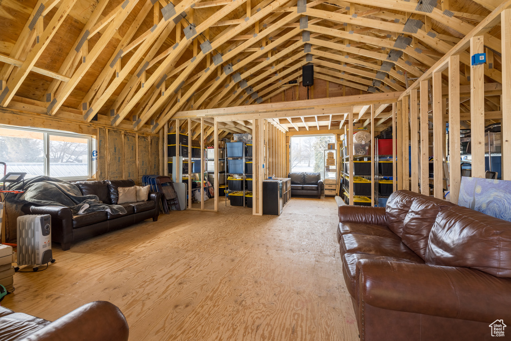 Living room featuring light hardwood / wood-style flooring, vaulted ceiling, and plenty of natural light