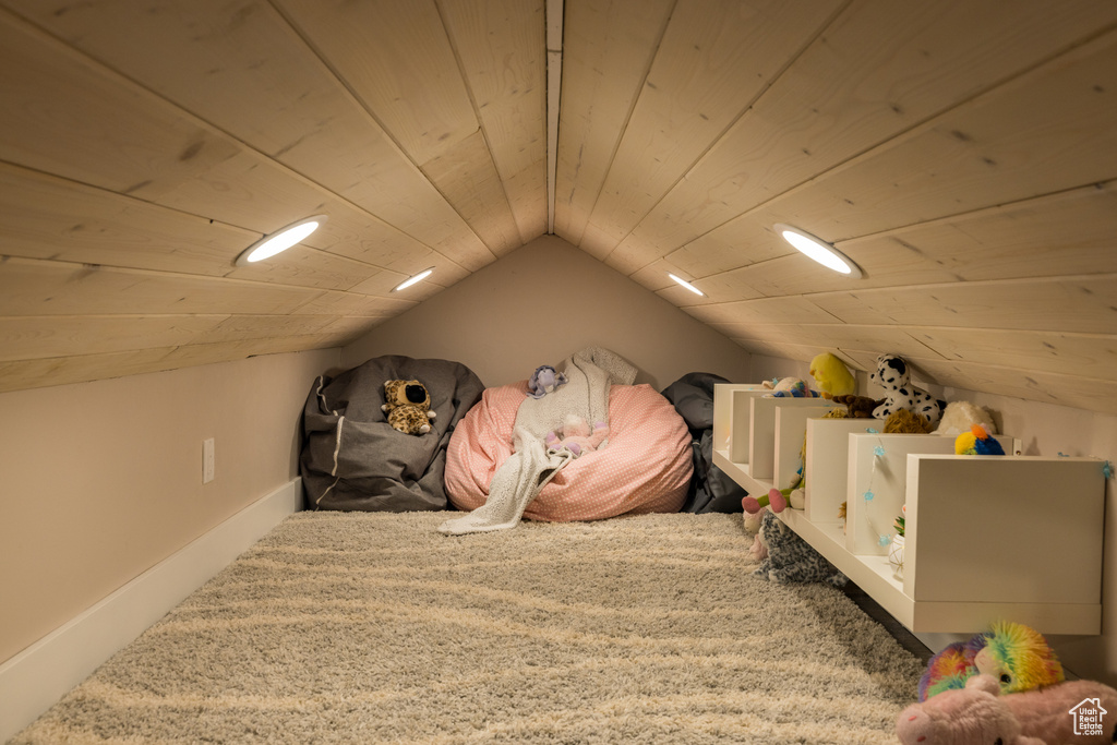 Bedroom with lofted ceiling, carpet, and wood ceiling