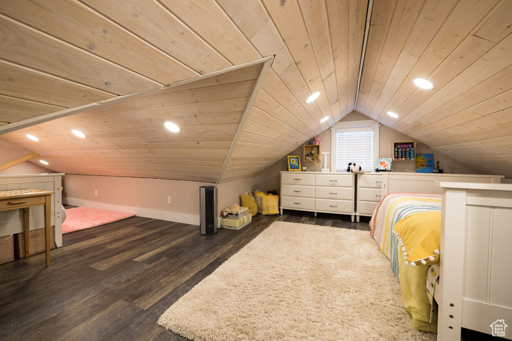 Bedroom with vaulted ceiling, dark hardwood / wood-style flooring, and wood ceiling