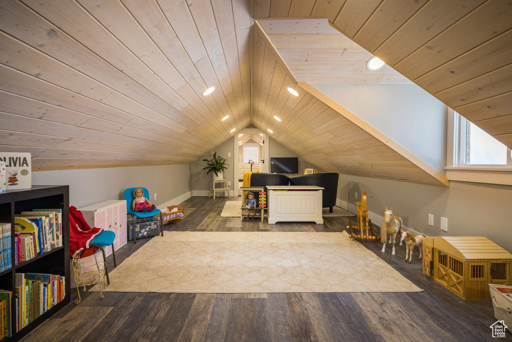 Playroom with vaulted ceiling, dark hardwood / wood-style flooring, and wooden ceiling