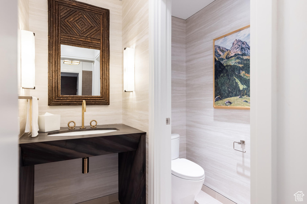 Bathroom featuring vanity, tile walls, tile flooring, and toilet