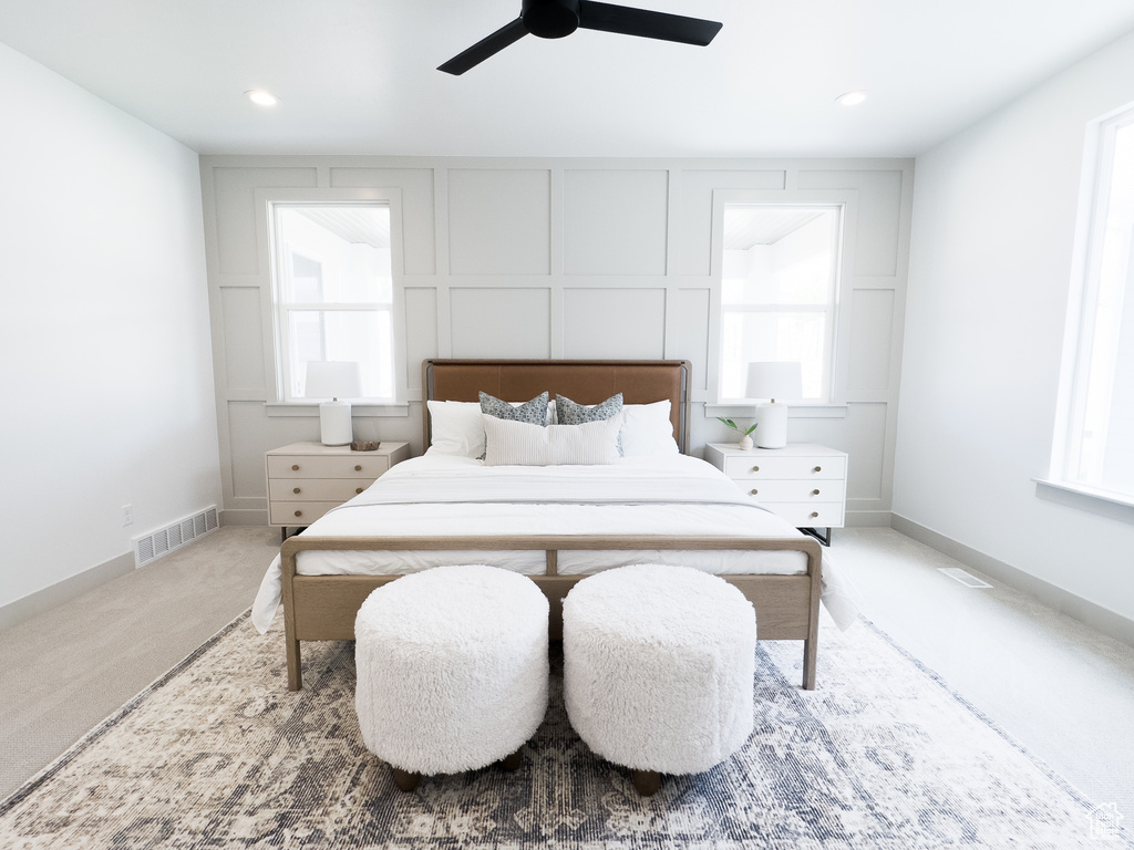 Carpeted bedroom with ceiling fan