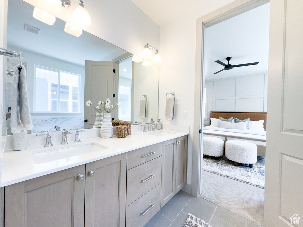 Bathroom with double vanity, ceiling fan, and tile floors