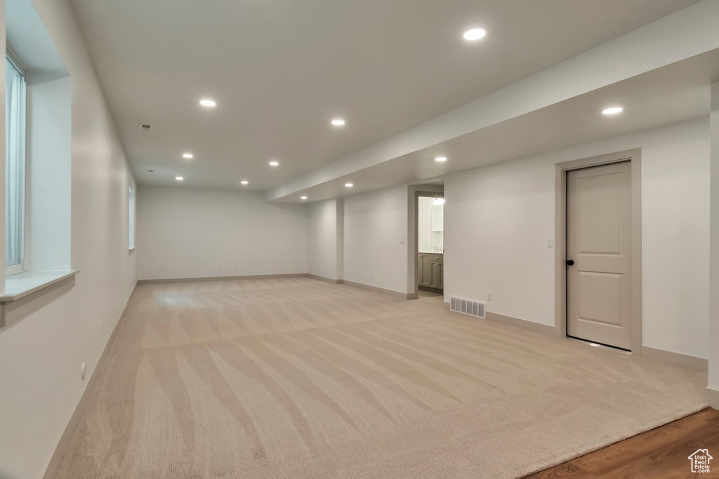 Basement with light colored carpet