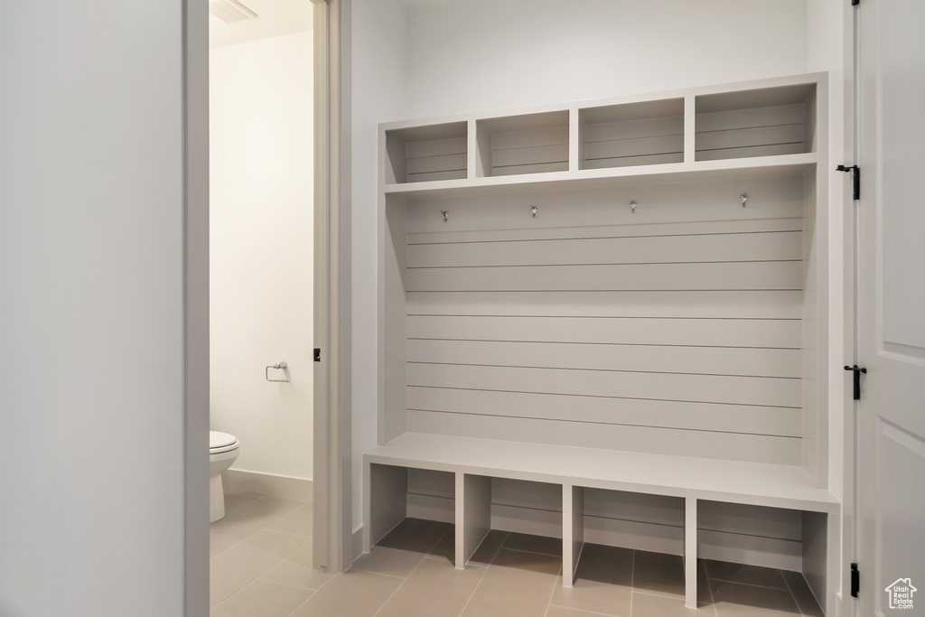 Mudroom featuring light tile floors