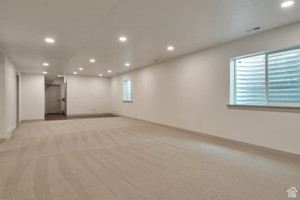 Interior space featuring light carpet and a healthy amount of sunlight