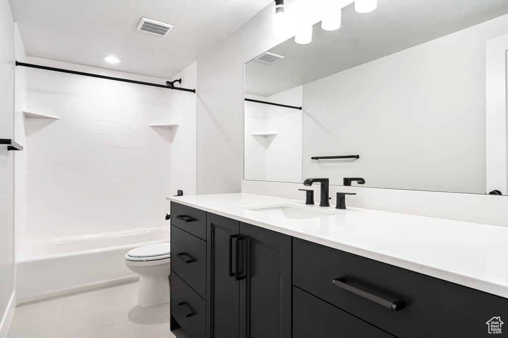 Full bathroom with tile flooring, vanity, toilet, and bathtub / shower combination