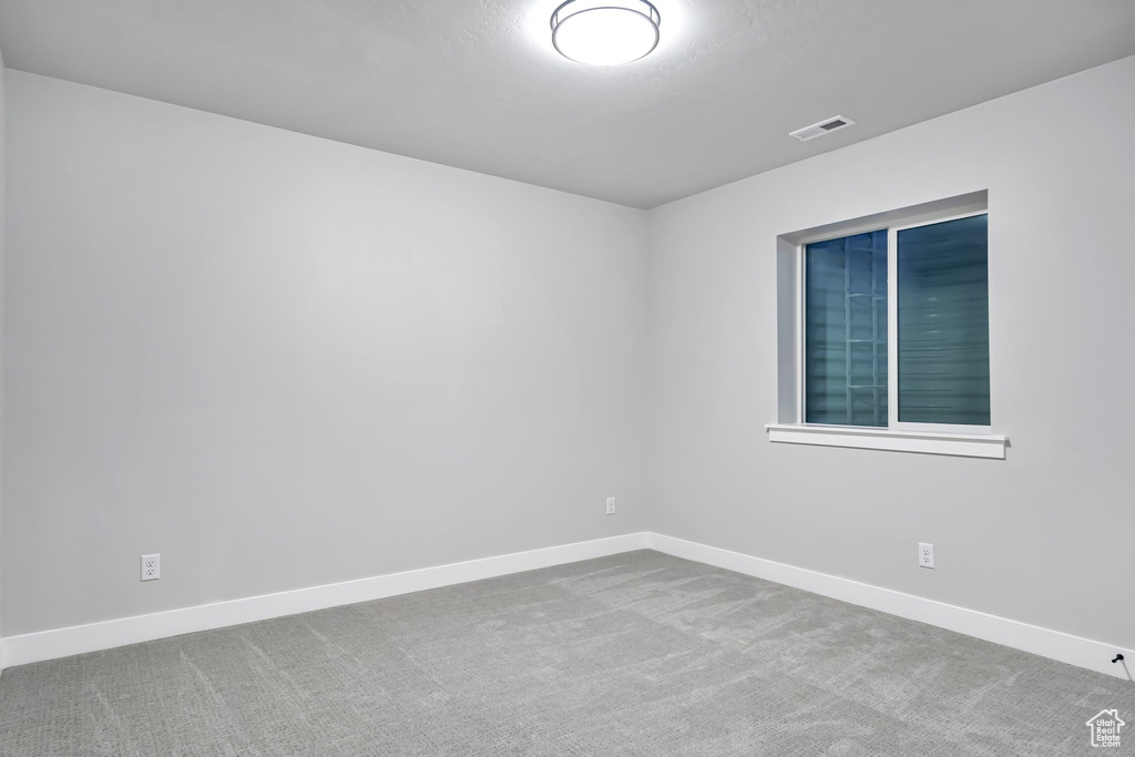 Unfurnished room featuring light colored carpet