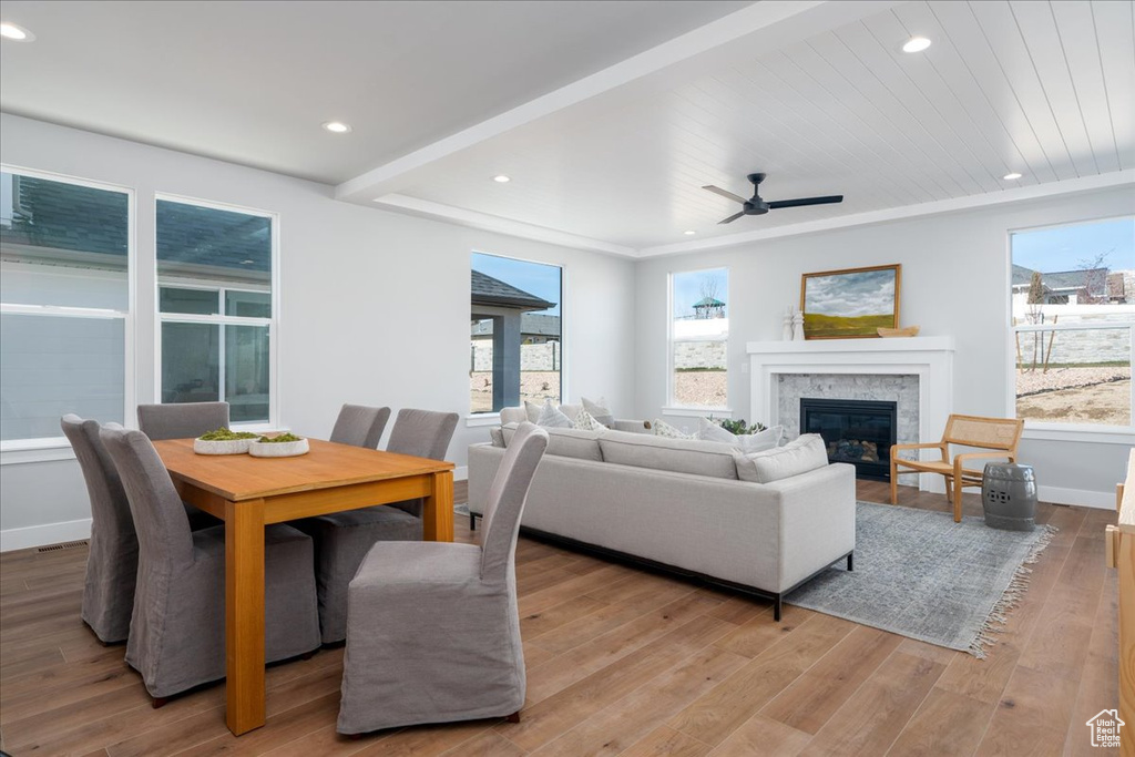 Dining area featuring light wood-type flooring, ceiling fan, and plenty of natural light