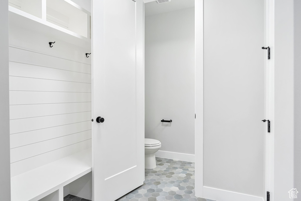 Bathroom with toilet and tile flooring