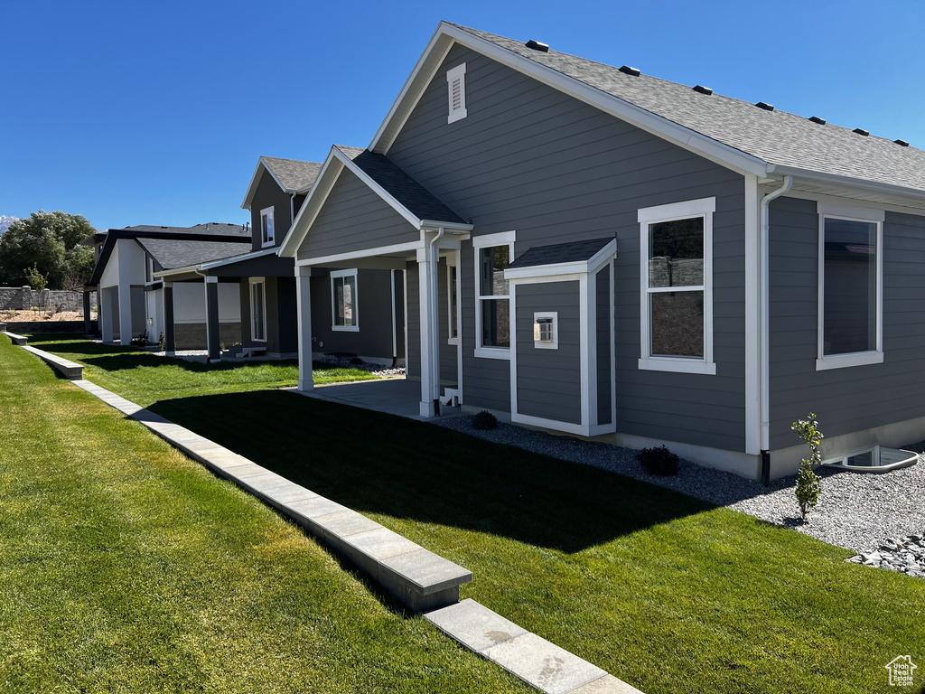 Rear view of house with a lawn