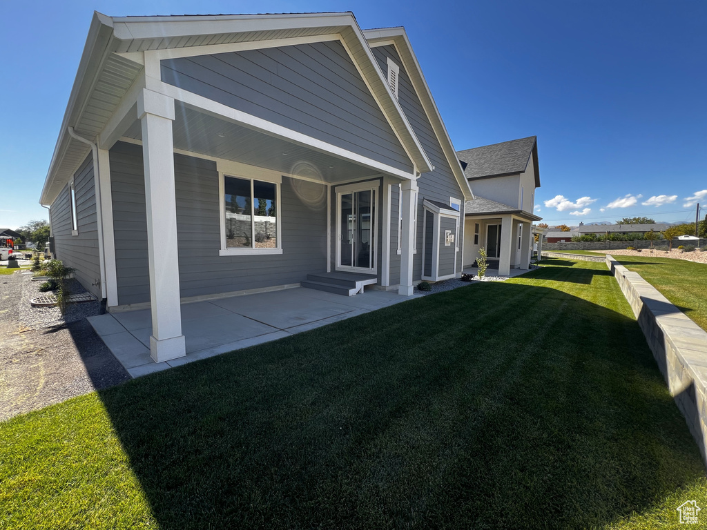 Rear view of property with a lawn