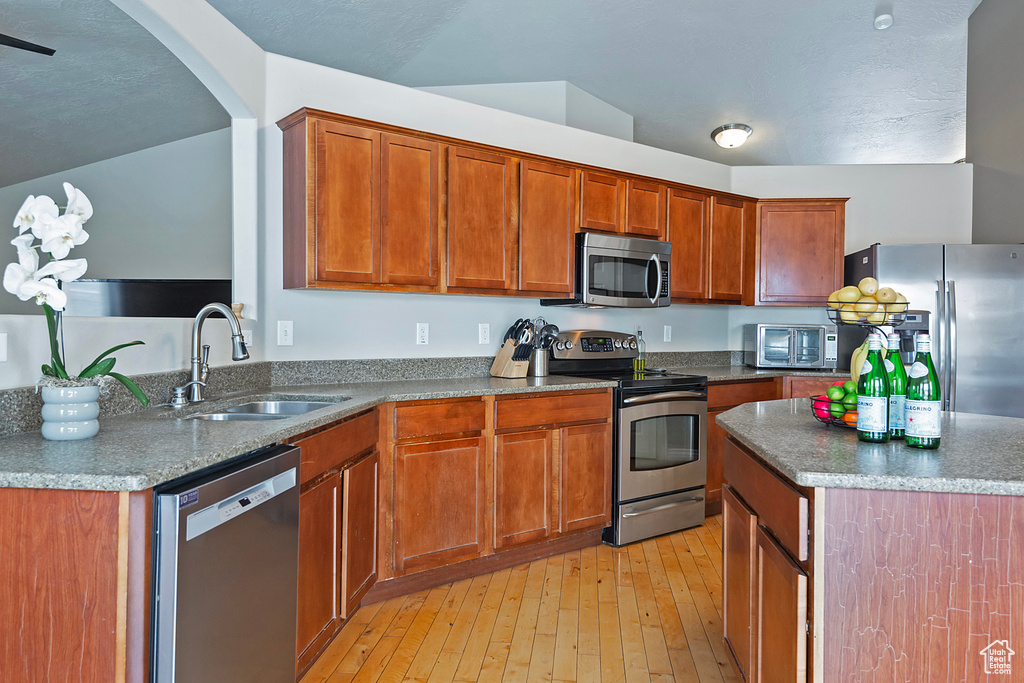 Kitchen featuring sink, light wood-type flooring, and appliances with stainless steel finishes