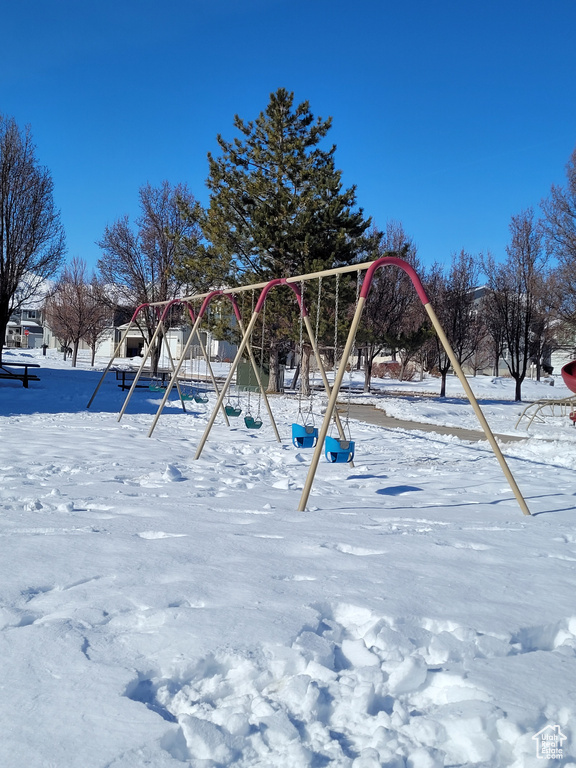 Snowy yard featuring a playground