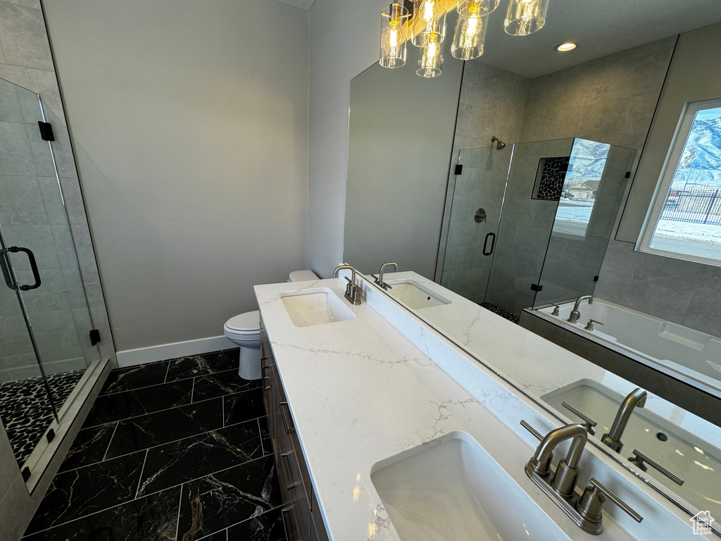 Bathroom featuring a chandelier, toilet, tile flooring, and double sink