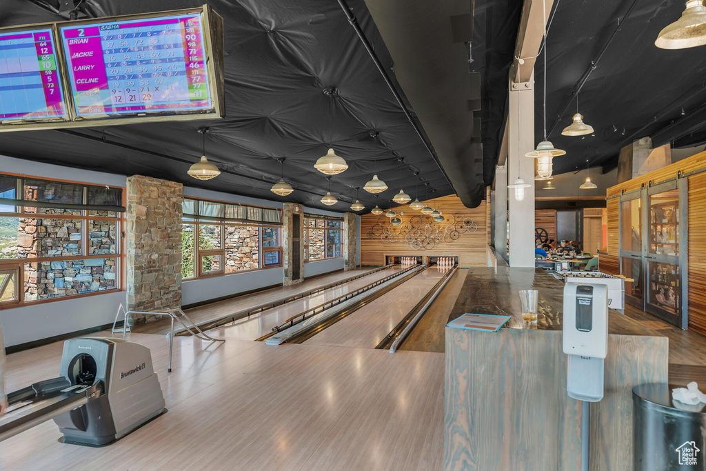 Recreation room with hardwood / wood-style floors and a bowling alley