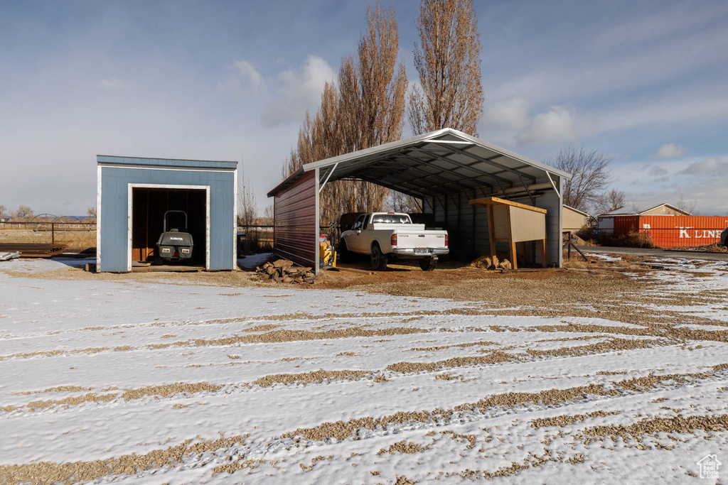 Snow covered structure with a carport