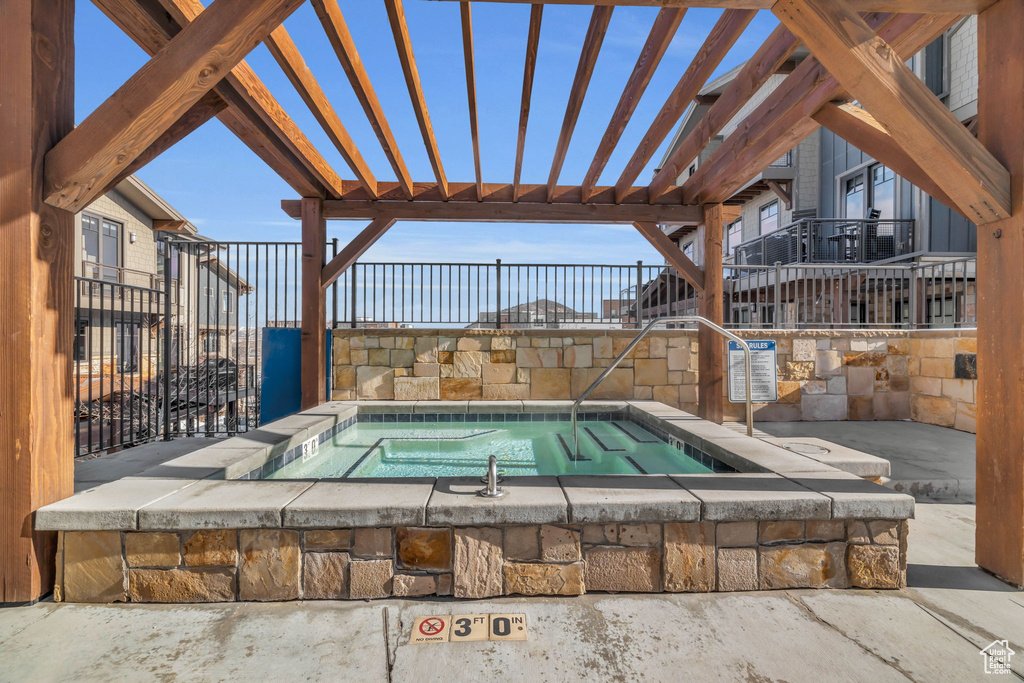 View of pool featuring a pergola, a hot tub, and a patio