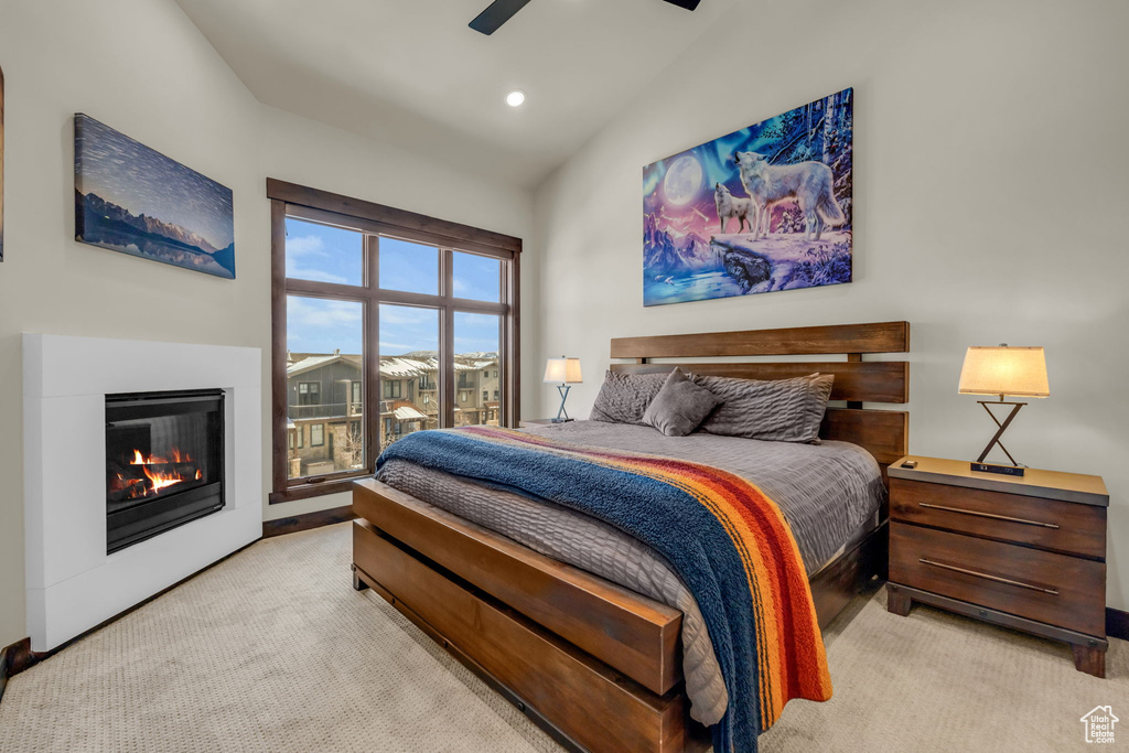 Bedroom featuring light carpet, lofted ceiling, access to outside, and ceiling fan