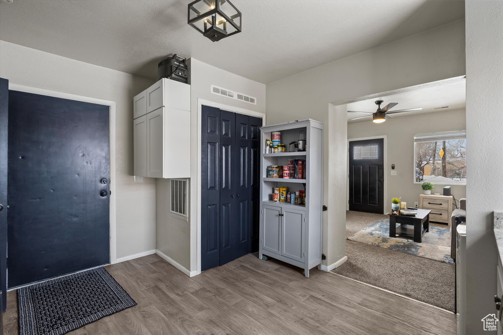 Entryway with light hardwood / wood-style flooring and ceiling fan