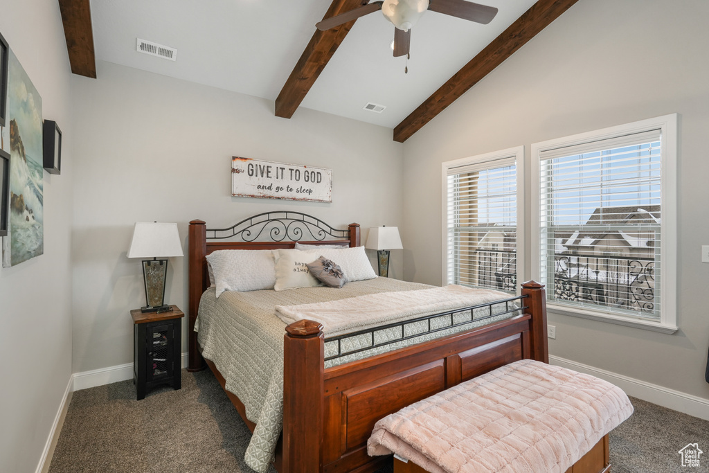 Bedroom with vaulted ceiling with beams, dark colored carpet, and ceiling fan