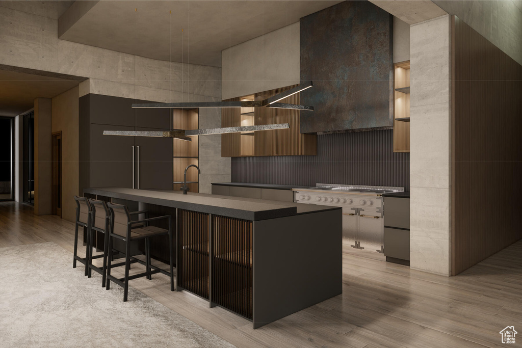 Kitchen featuring tasteful backsplash, light wood-type flooring, a breakfast bar area, and stovetop