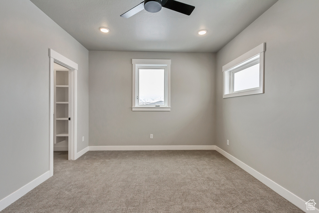 Spare room with light carpet and ceiling fan