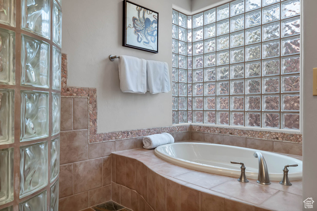 Bathroom featuring a relaxing tiled bath