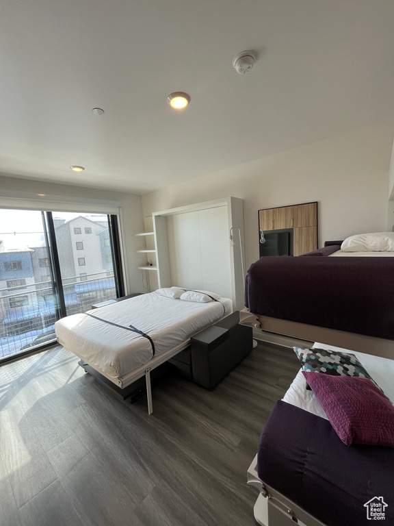Bedroom featuring dark hardwood / wood-style flooring and access to exterior