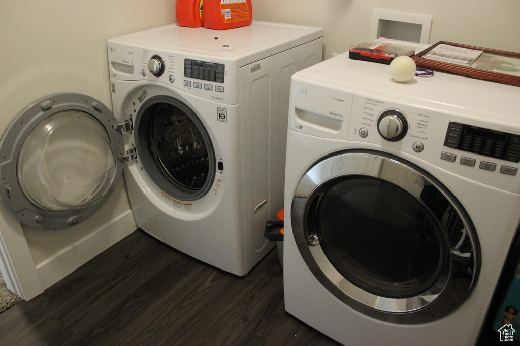 Clothes washing area with dark wood-type flooring, independent washer and dryer, and hookup for a washing machine