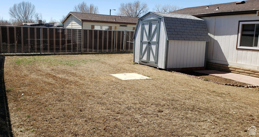 View of yard with a storage unit