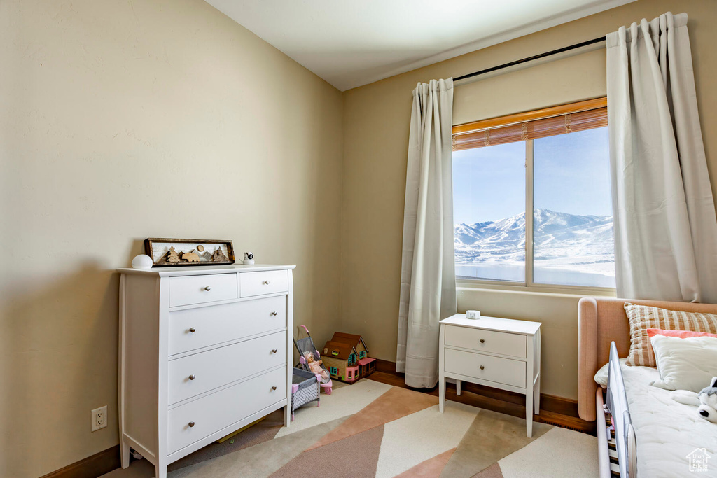 Carpeted bedroom featuring a mountain view