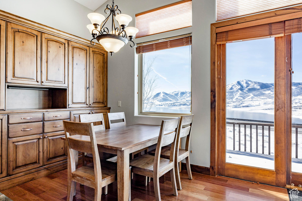Dining space featuring light hardwood / wood-style floors, a notable chandelier, and a mountain view