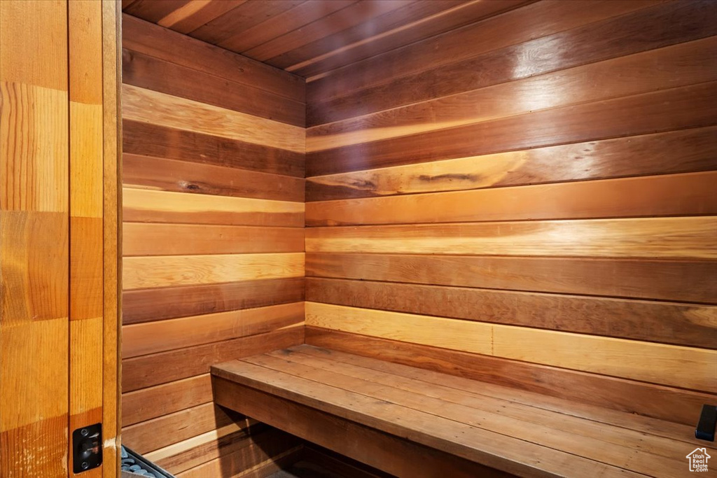View of sauna / steam room with wooden ceiling and wooden walls
