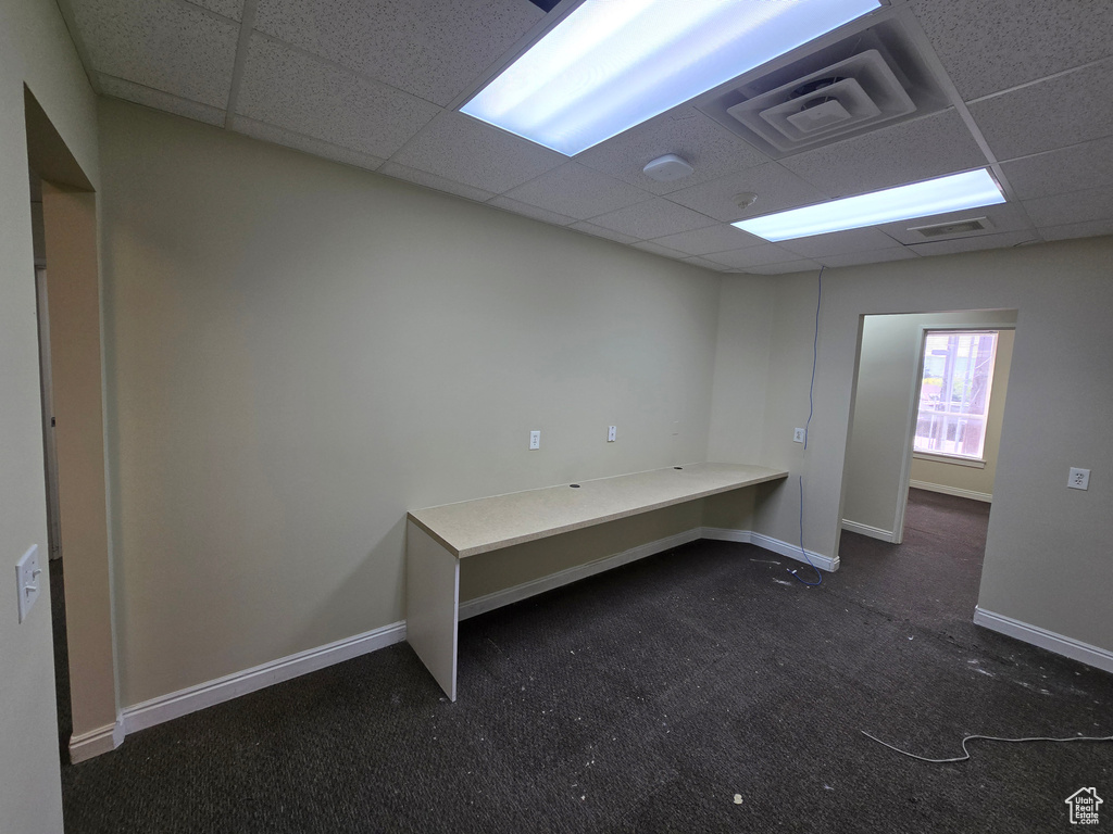 Unfurnished office featuring a drop ceiling and carpet