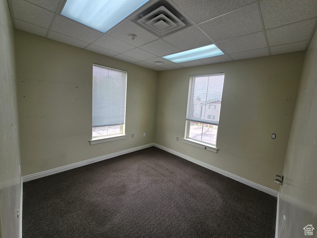 Carpeted spare room with a paneled ceiling