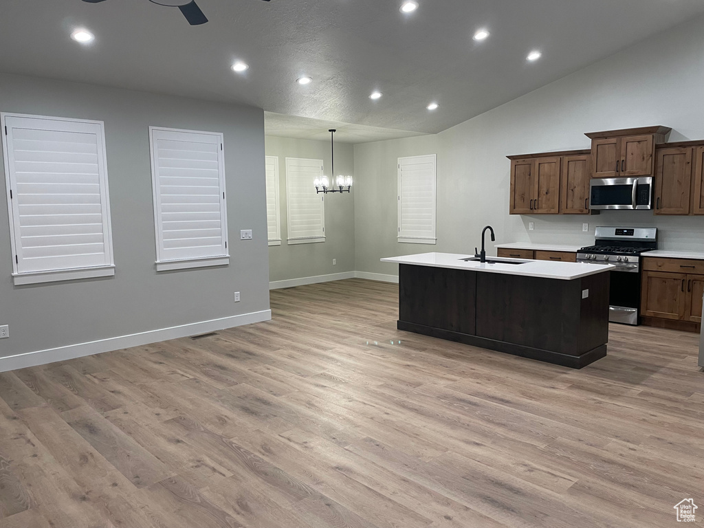Kitchen featuring sink, light wood-type flooring, and appliances with stainless steel finishes