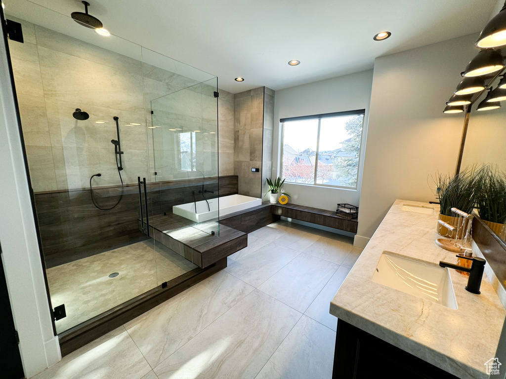 Bathroom with tile floors, an enclosed shower, and dual bowl vanity