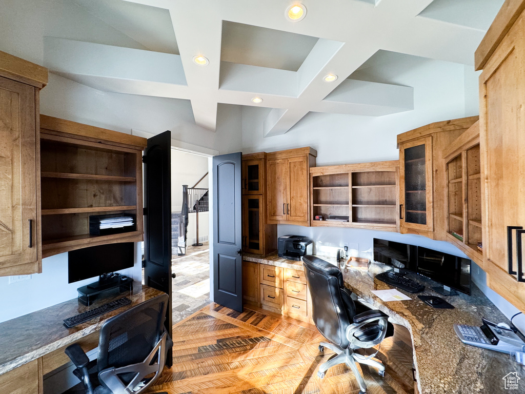 Office area featuring beam ceiling, coffered ceiling, and light hardwood / wood-style flooring