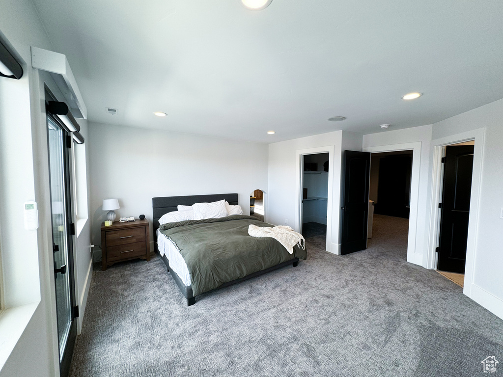 Bedroom with carpet flooring, a closet, and a spacious closet
