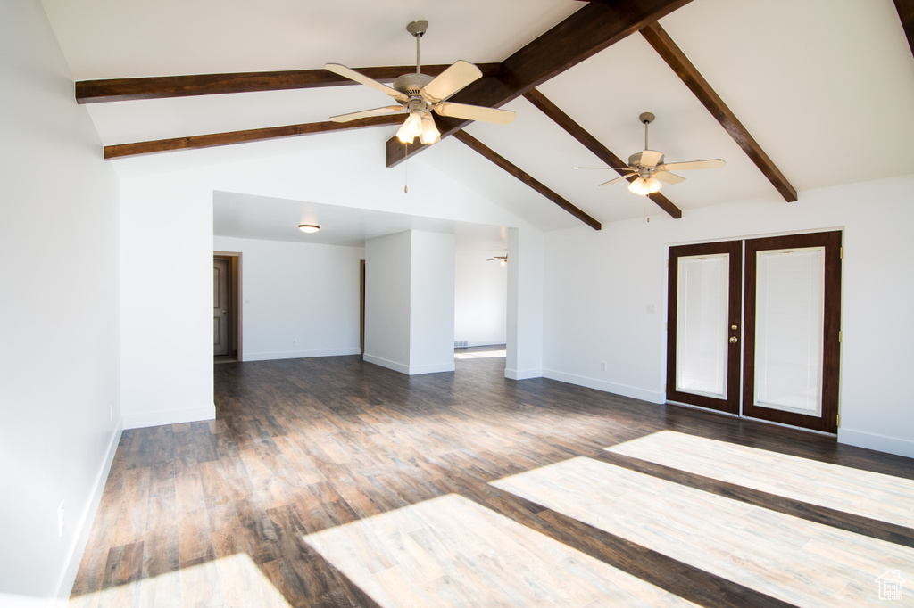 Spare room featuring high vaulted ceiling, dark hardwood / wood-style floors, ceiling fan, and beamed ceiling