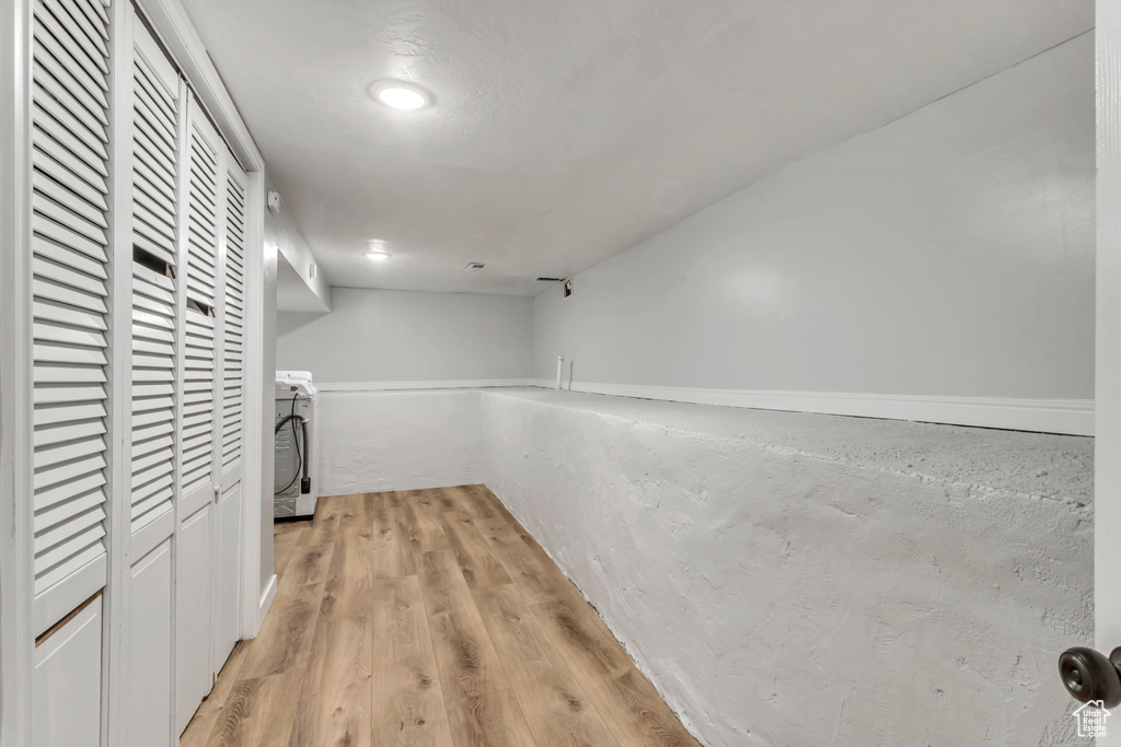 Interior space featuring washer / clothes dryer and light hardwood / wood-style floors
