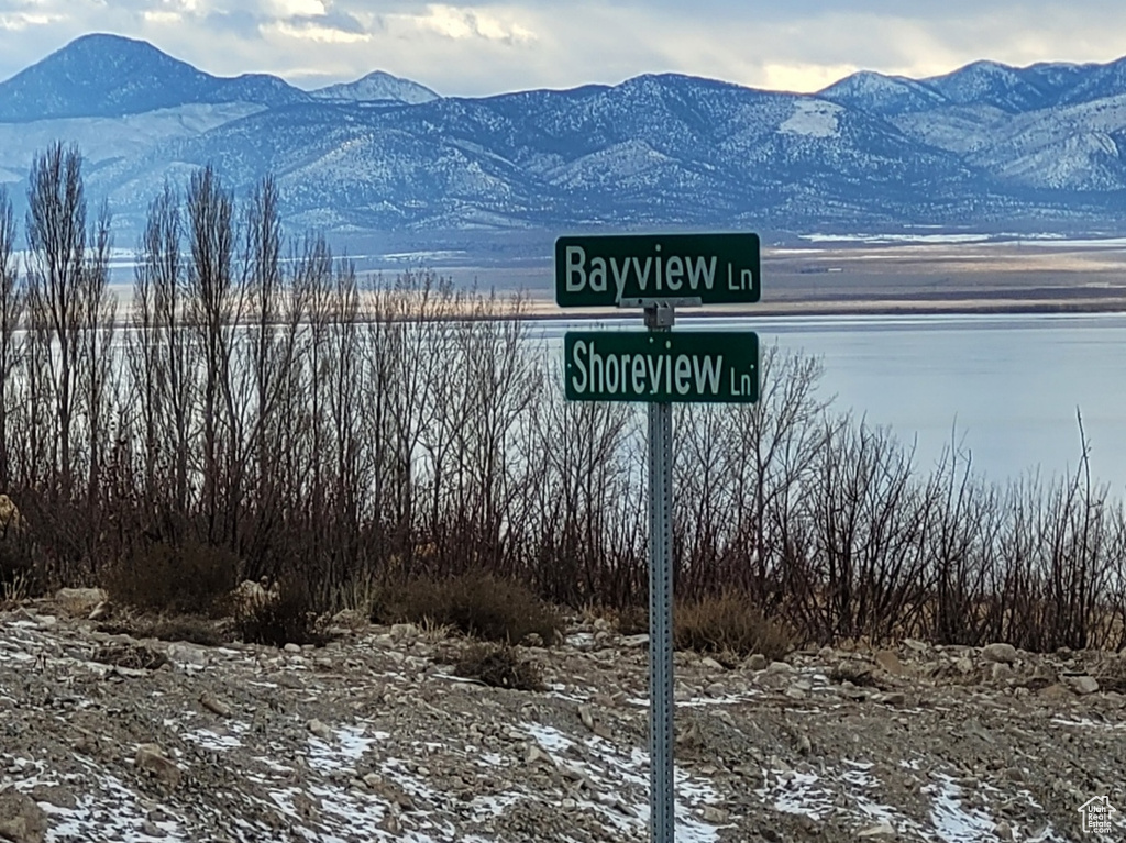 Community / neighborhood sign with a mountain view