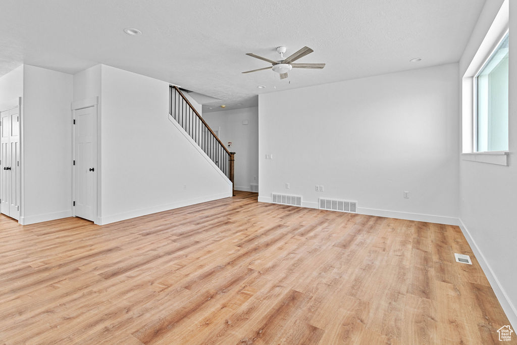 Empty room featuring light hardwood / wood-style floors and ceiling fan