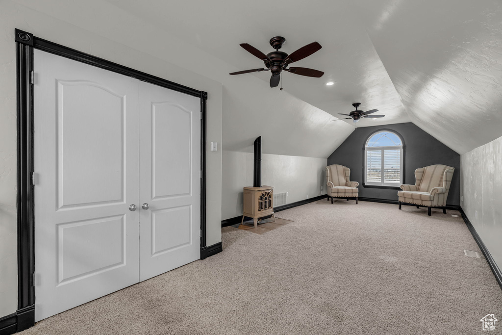 Unfurnished bedroom with vaulted ceiling, light colored carpet, a closet, and ceiling fan