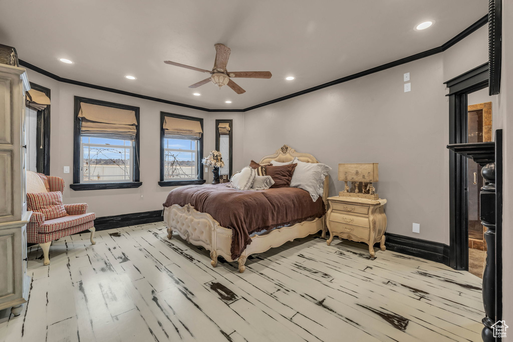 Bedroom featuring crown molding, light hardwood / wood-style floors, and ceiling fan