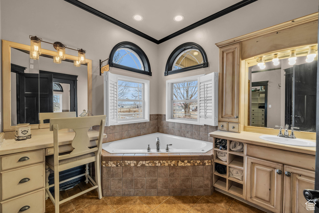 Bathroom with tile flooring, tiled bath, ornamental molding, and oversized vanity