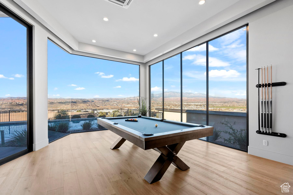 Game room with light wood-type flooring and pool table