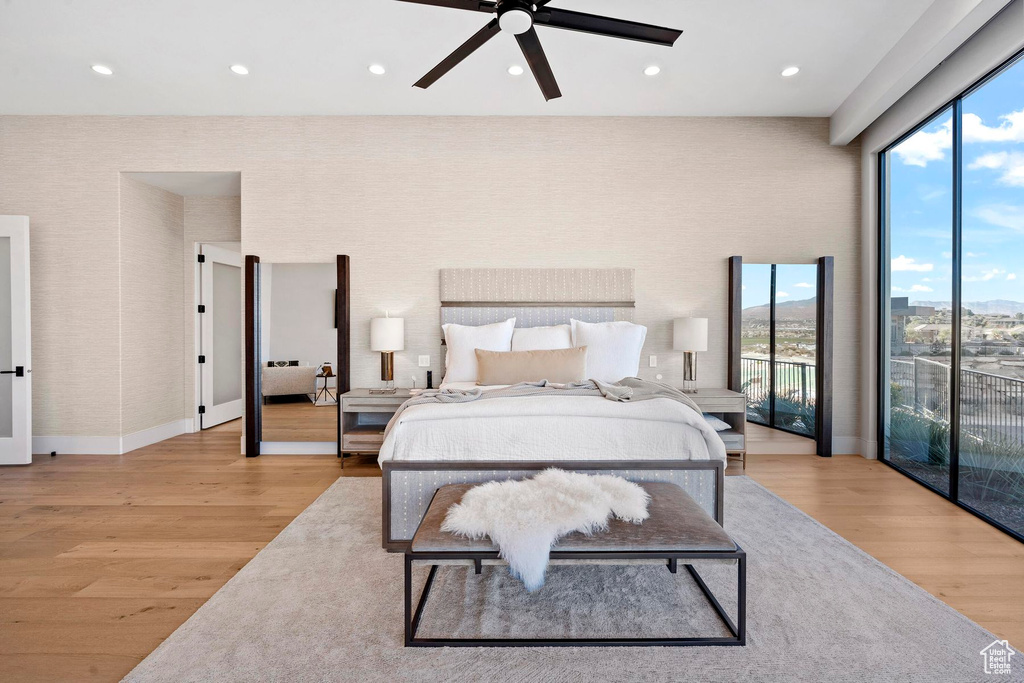 Bedroom with light wood-type flooring, access to exterior, and ceiling fan