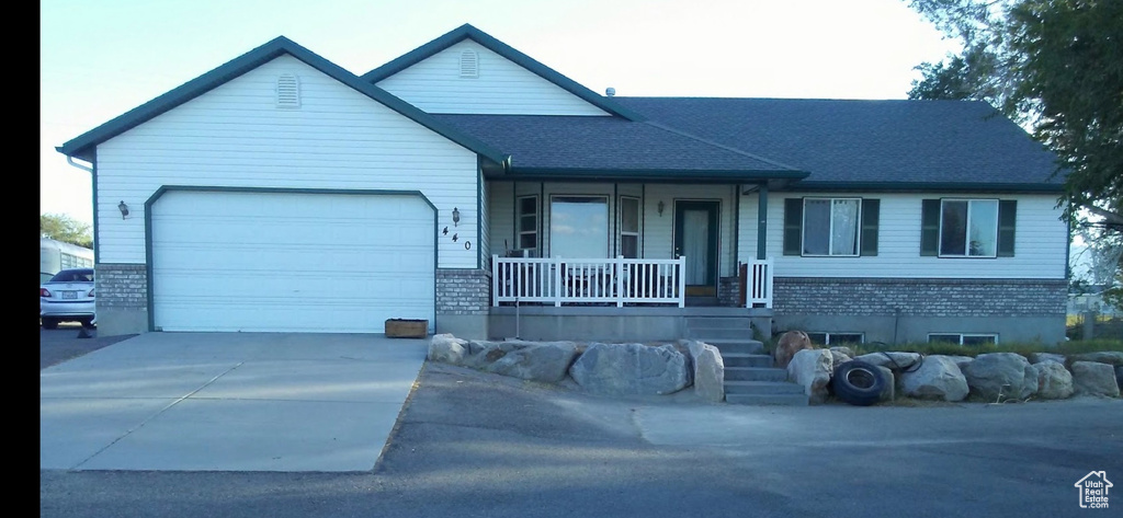 View of front of home with a garage and covered porch